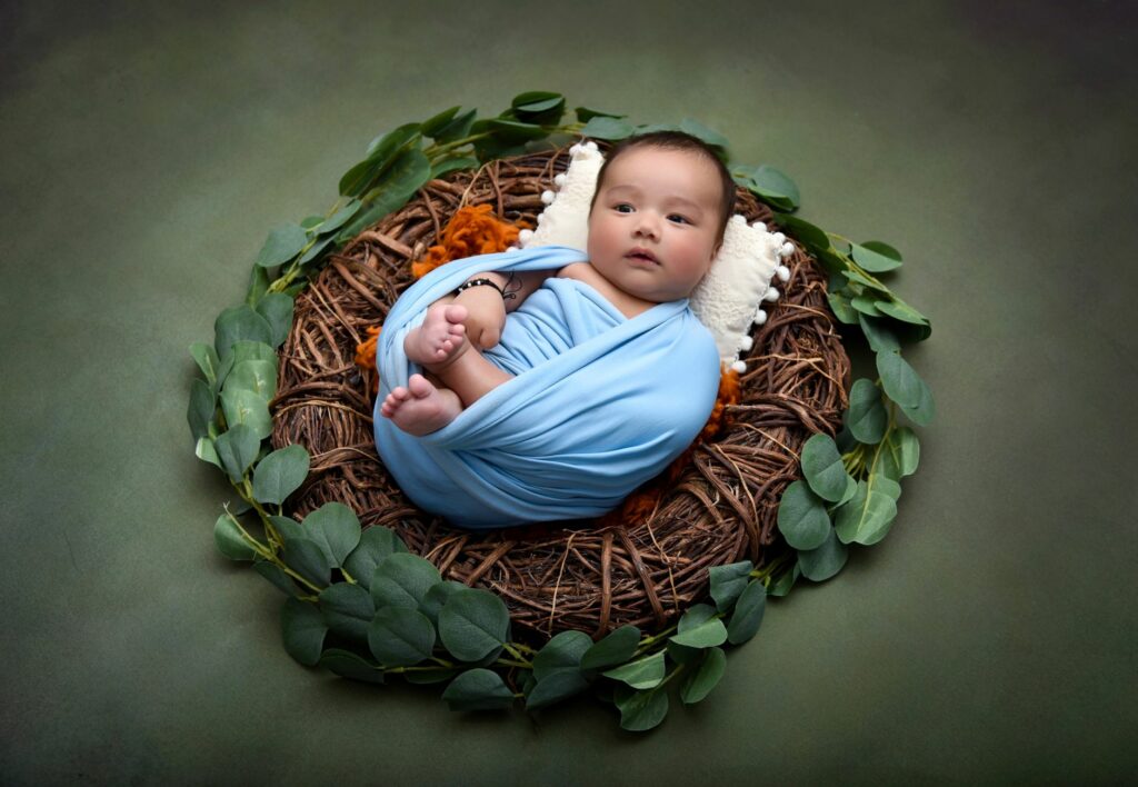 baby boy lying down on a nest